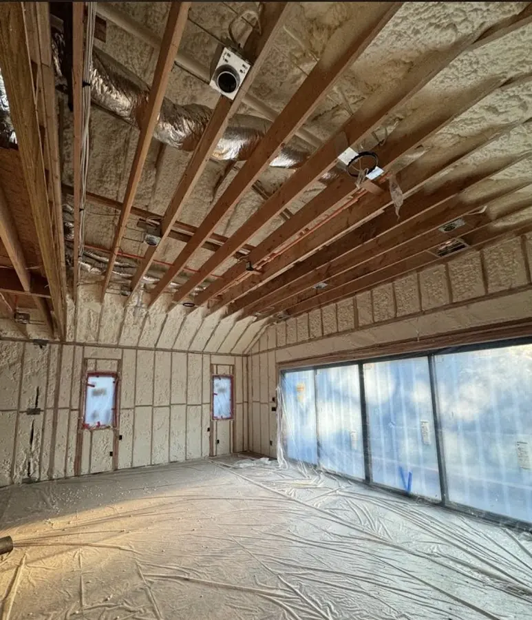 Interior walls and ceiling insulated with spray foam during new construction in Needham